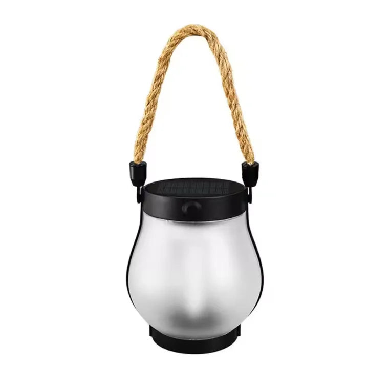 Unlit lantern with frosted glass body, black top and rope handle on a white background 11