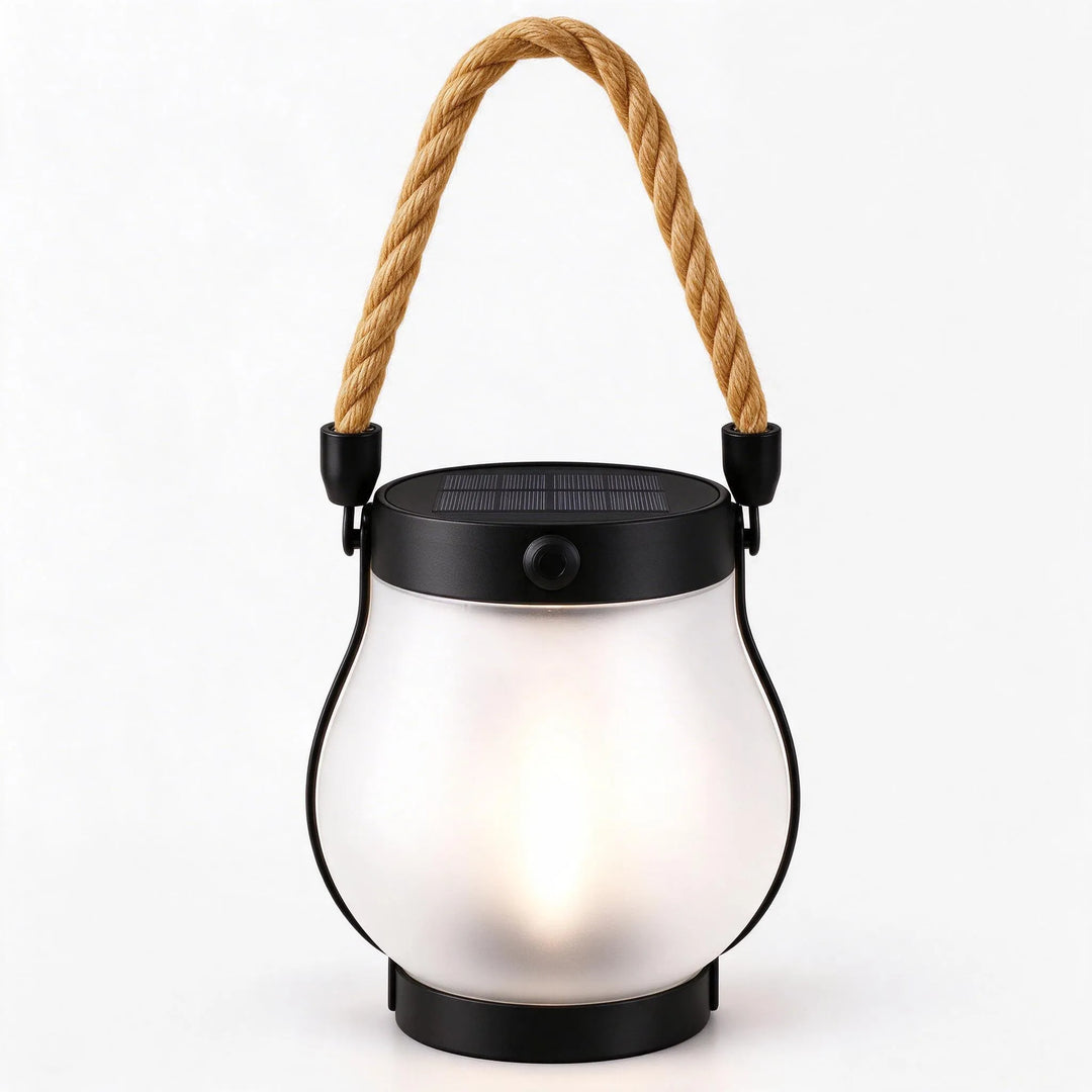 Frosted glass lantern with a soft warm glow, solar panel on top and rope handle 12