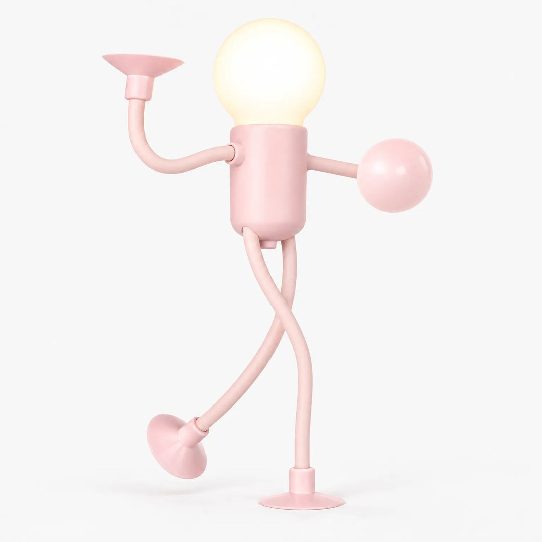 Pink posable figure light with a glowing round bulb head, one arm raised and legs crossed 1
