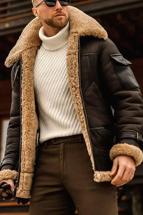 Dark brown version of the shearling-lined jacket worn open over a cream ribbed polo-neck and brown trousers 7