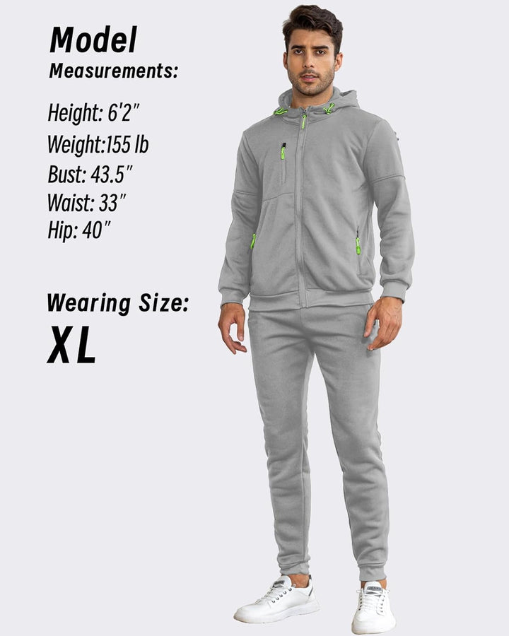 Model wearing the grey tracksuit from the front, beside his height and size information 26