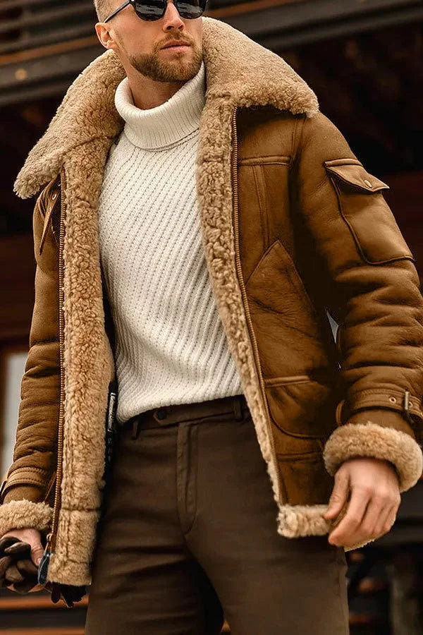 Tan-brown version of the shearling-lined jacket worn open over a cream ribbed polo-neck and brown trousers 6