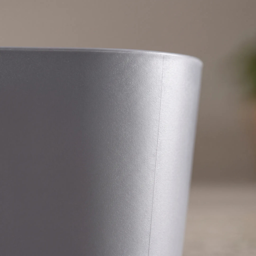Close-up of the grey plastic basin's smooth, matt outer wall and rounded rim, showing a faint moulding seam. 3