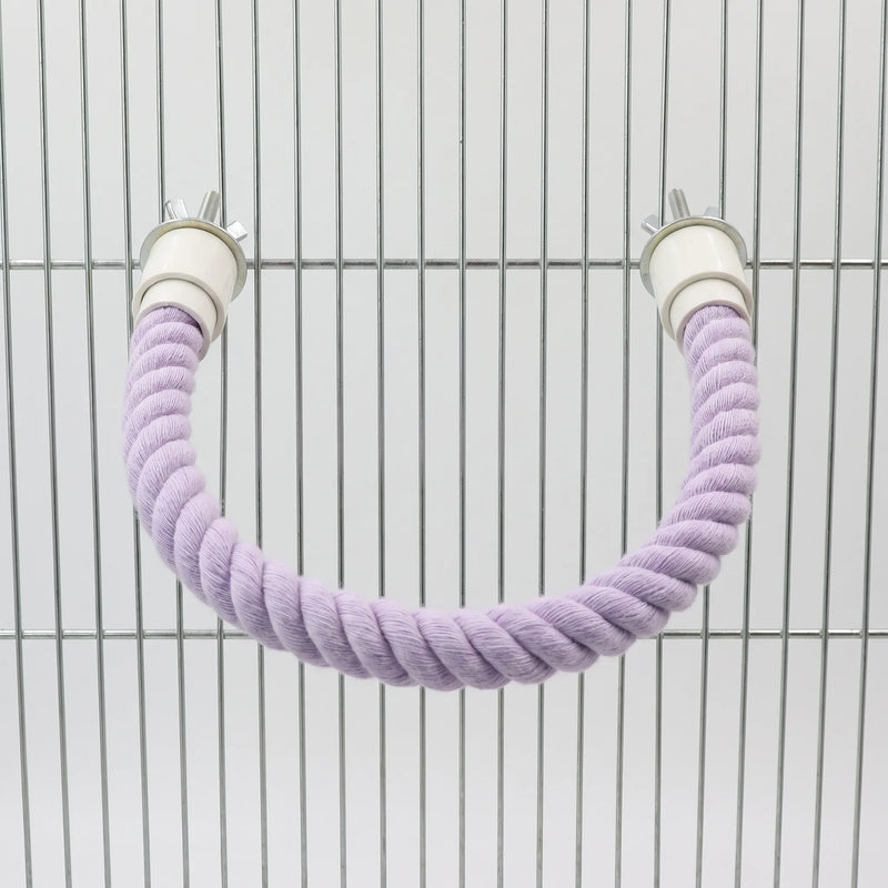 Lilac rope perch bent into a U-shape and bolted to the bars of a metal cage using wing nuts. 5