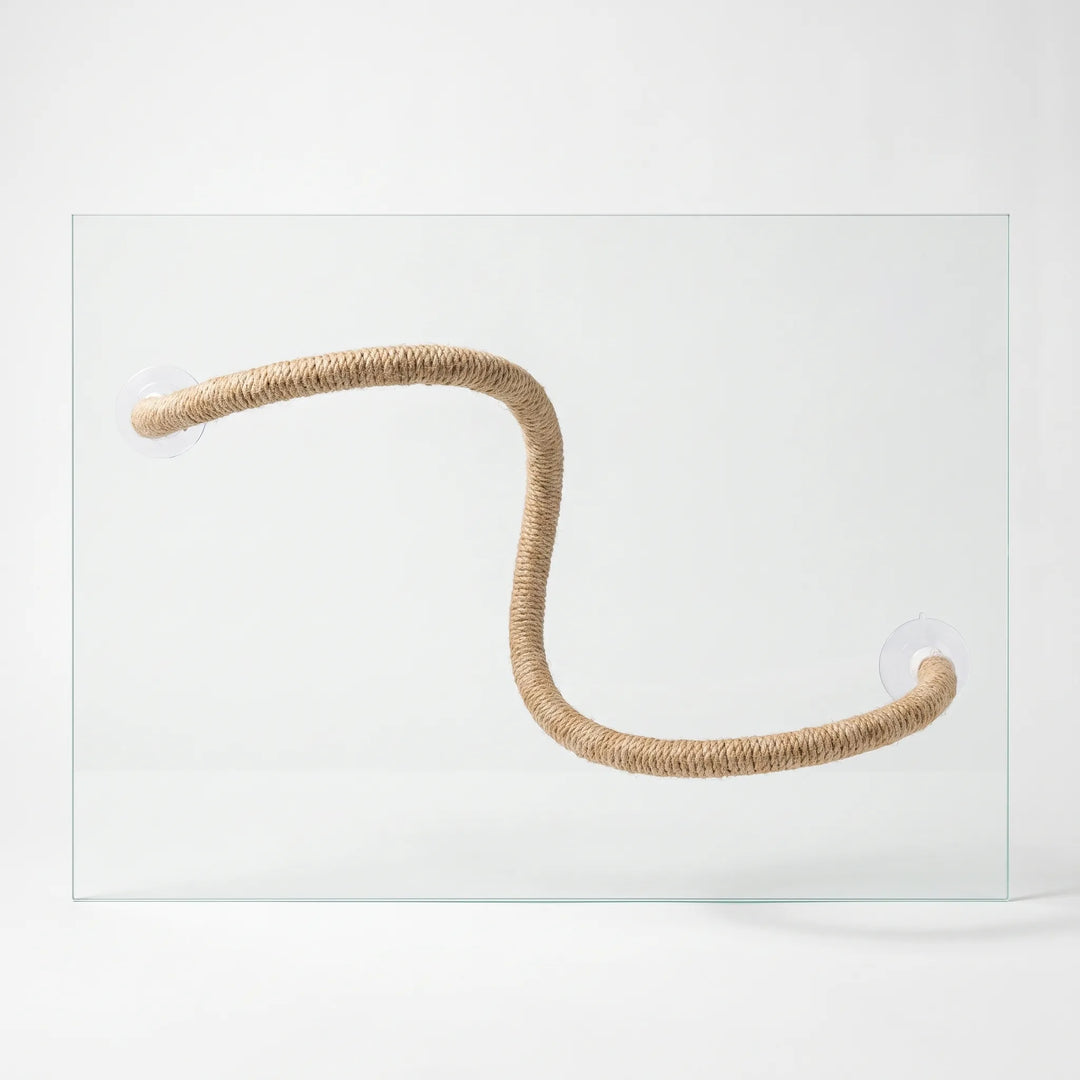 Bendable natural rope perch bent into an S shape, held against a sheet of clear glass by a suction cup at each end. 1