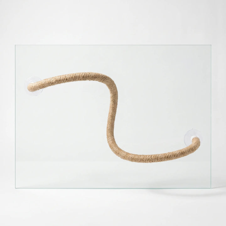 Bendable natural rope perch bent into an S shape, held against a sheet of clear glass by a suction cup at each end. 1