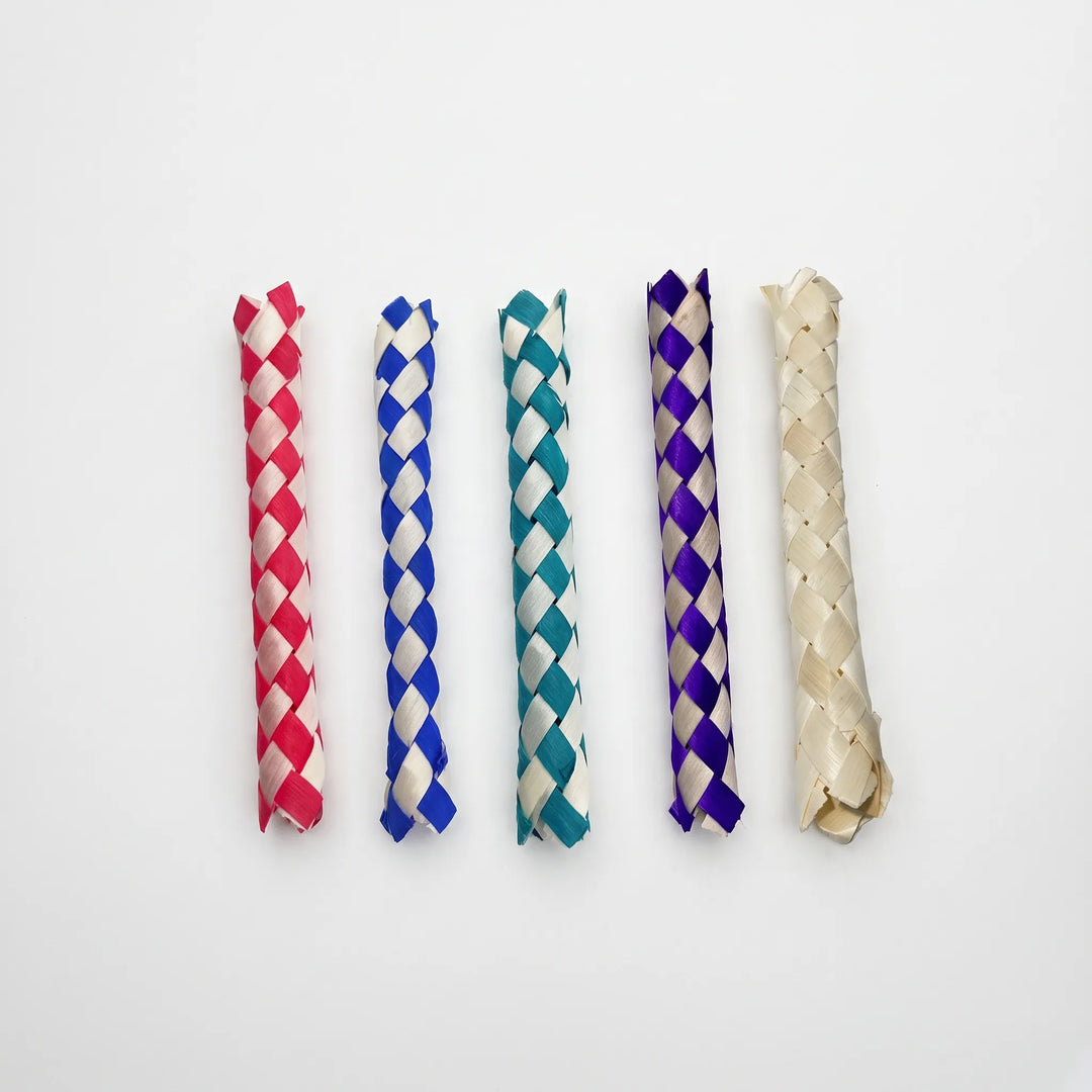 Five woven finger traps lined up side by side on a white background in red, blue, teal, purple and plain natural. 1