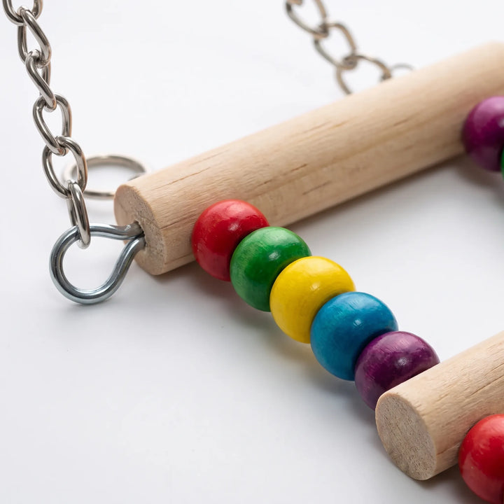 Close-up of the wooden ladder rungs strung with glossy red, green, yellow, blue and purple beads, with the metal chain and ring. 3