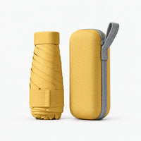 Mustard yellow folded umbrella and matching hard zip case with grey wrist loop, shown on a plain white background. 11
