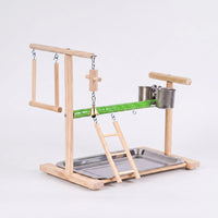 Wooden bird playstand seen from the opposite angle, showing the swing on the left, bell, ladder, two steel cups and tray. 4