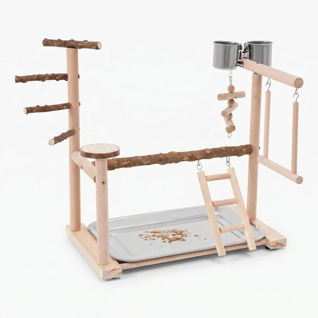 Wooden bird play stand on a plain white background, with natural branch perches, ladder, swing, two steel cups and a seed tray. 1