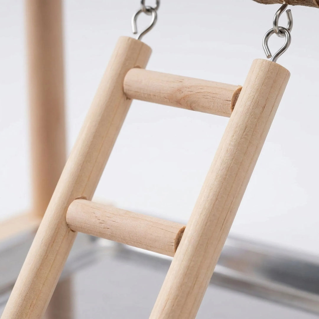 Close-up of the small wooden hanging ladder, showing its round rungs and metal screw hooks above the steel tray. 4