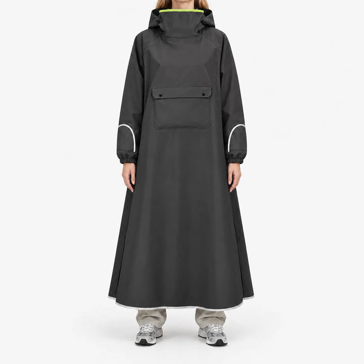 Front view of a model in the black version of the long poncho, with chest flap pocket, reflective sleeve and hem trim, and neon lime collar lining. 4