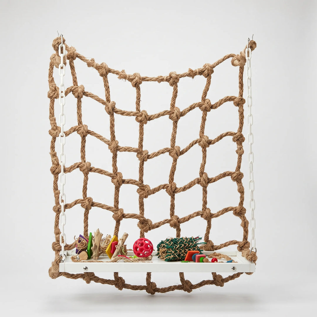 Natural rope climbing net hung by white plastic chains above a white platform holding colourful toys, shown against a plain background. 1