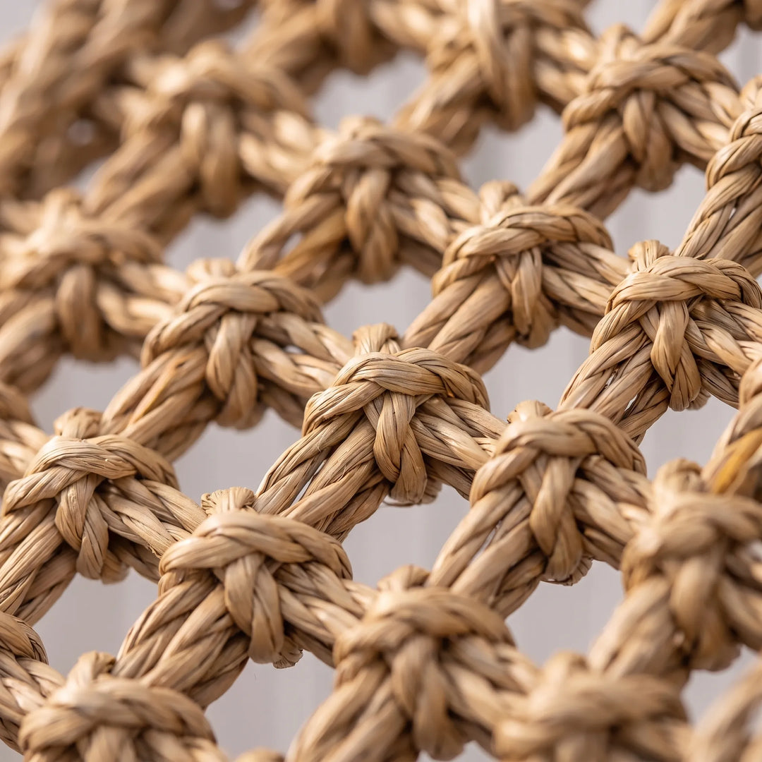 Close-up of the twisted, knotted natural fibre weave, showing the texture of the knots and the open gaps between them. 3