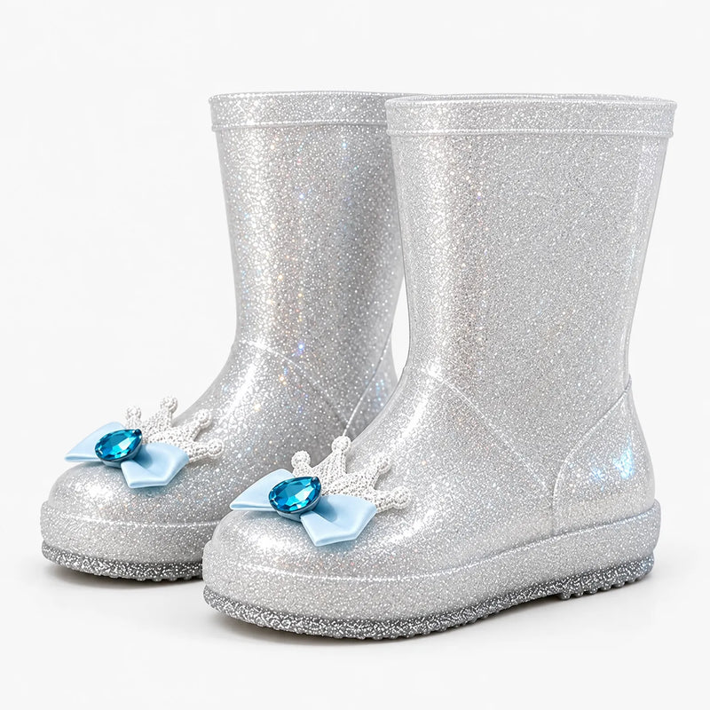 Pair of silver glitter rain boots at an angle, each toe decorated with a white crown, pale blue bow and blue gem. 8