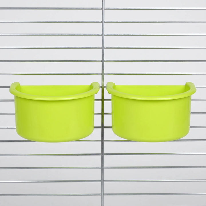 Two green half-round bowls hanging side by side on the metal bars of a cage, seen from the front. 4