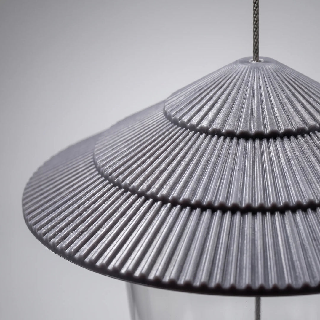 Close-up of the grey tiered, ribbed roof, showing its fine radial ridges and the steel cable passing through the top. 3