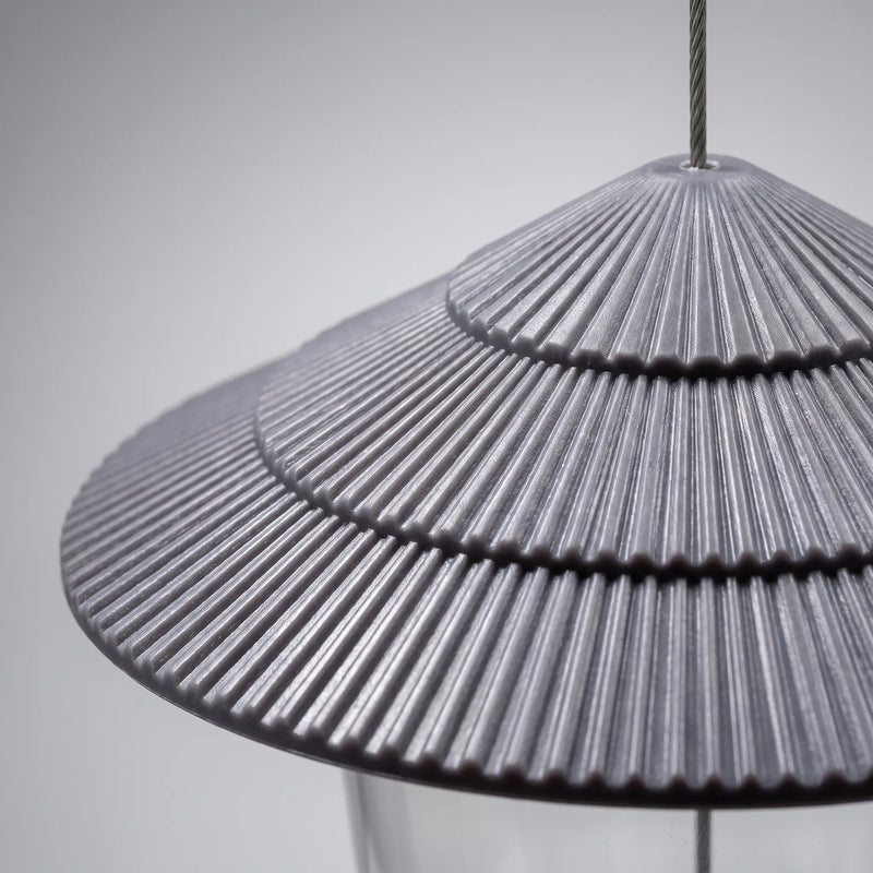 Close-up of the grey tiered, ribbed roof, showing its fine radial ridges and the steel cable passing through the top. 3