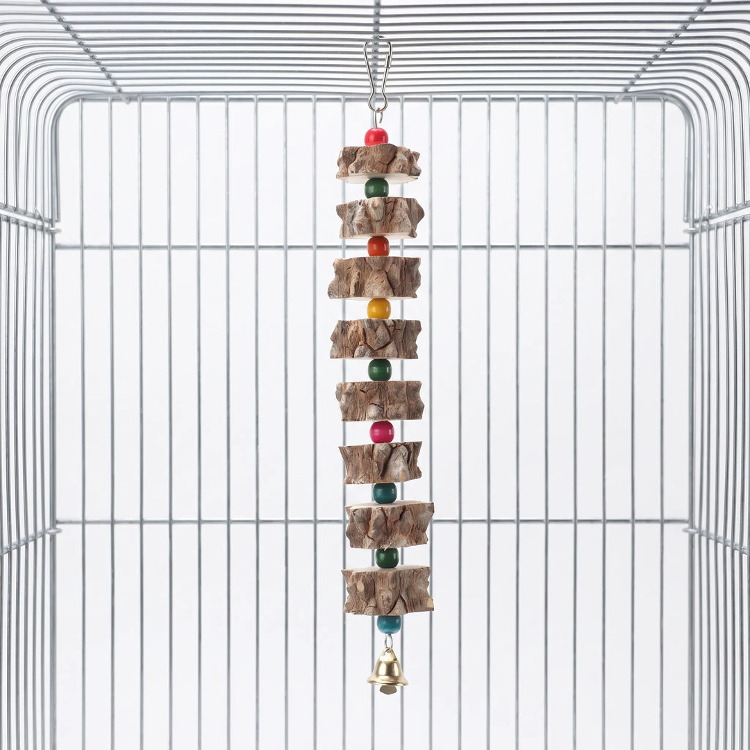 Hanging bird toy with bark-edged wooden slices, colourful beads and a small gold bell, hooked inside an empty wire cage. 1