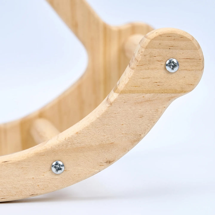 Close-up detail of the curved wooden base of the swing, showing the natural wood grain, silver screws and a dowel rung. 3