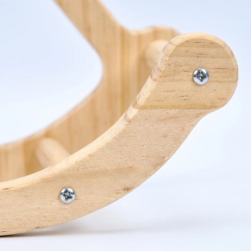 Close-up detail of the curved wooden base of the swing, showing the natural wood grain, silver screws and a dowel rung. 3