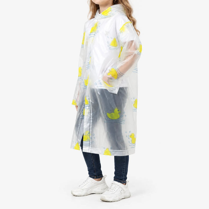 Side view of a girl in the clear raincoat with yellow rubber duck print, showing the hood, snap closure and a hand in the pocket. 5