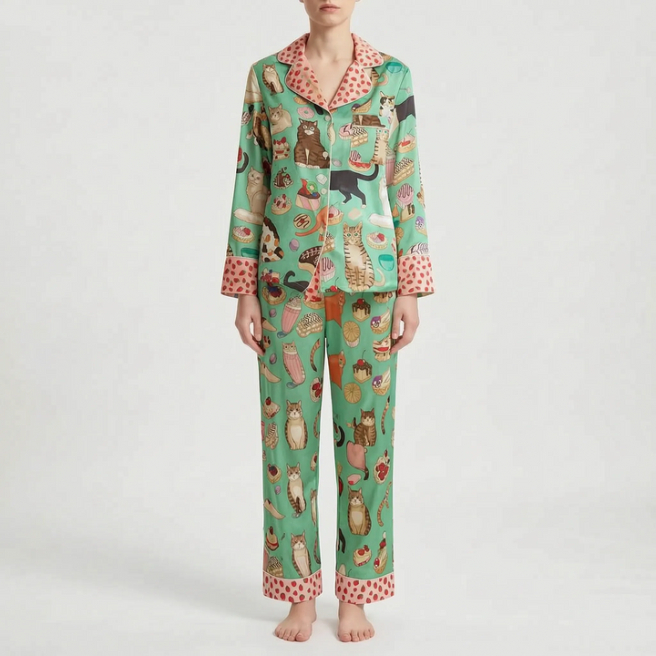 Model wearing a different pyjama print in green with cats and pastries, finished with pink strawberry-patterned collar and cuffs. 6