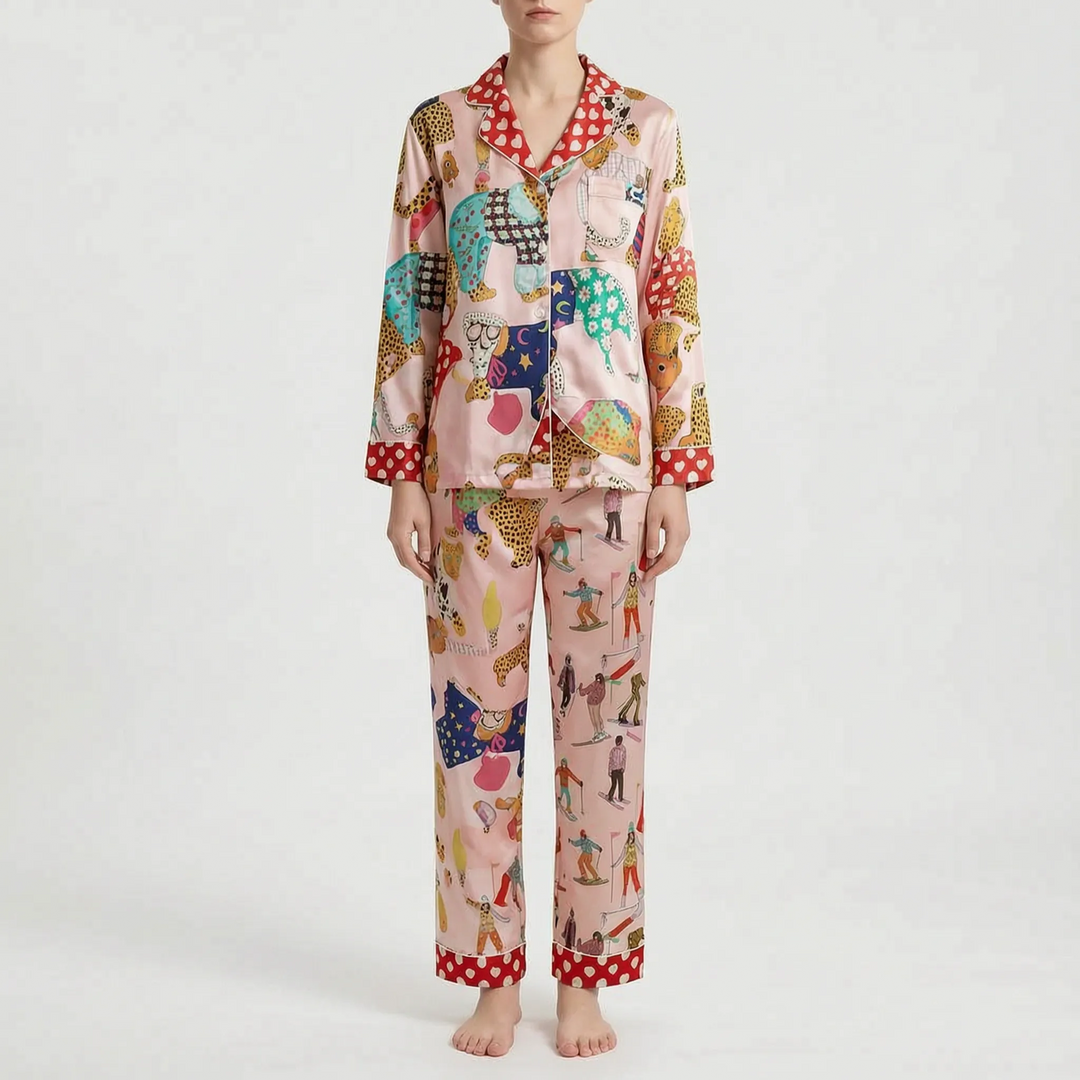 Model wearing another print option in pink with leopards and skiers, with red heart-patterned collar, cuffs and trouser hems. 7
