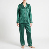 Front view of the green satin pyjama set with white piping, worn by a model on a light grey background. 12