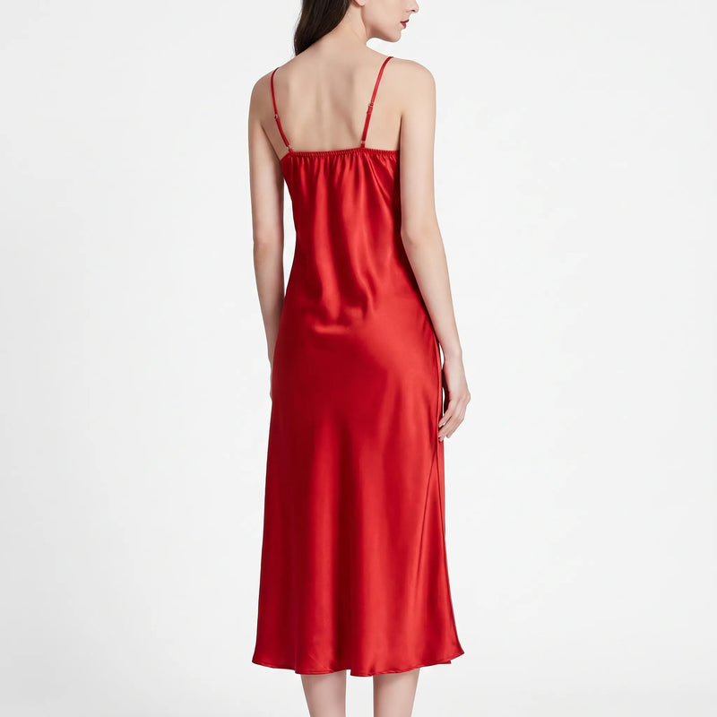 Back view of the red satin nightdress on a model, showing thin adjustable straps, gathered back neckline and flowing skirt. 3