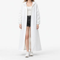 Studio front view of the white hooded raincoat worn open with snap buttons, elastic cuffs and drawstring hood over shorts. 2
