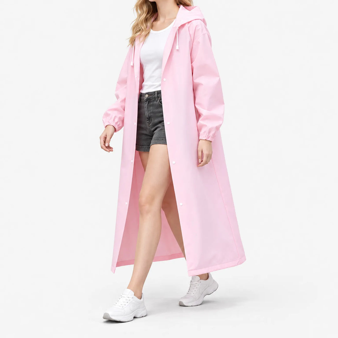 Woman walking in the pink hooded raincoat worn open over a white tee and denim shorts, shown from the side. 5