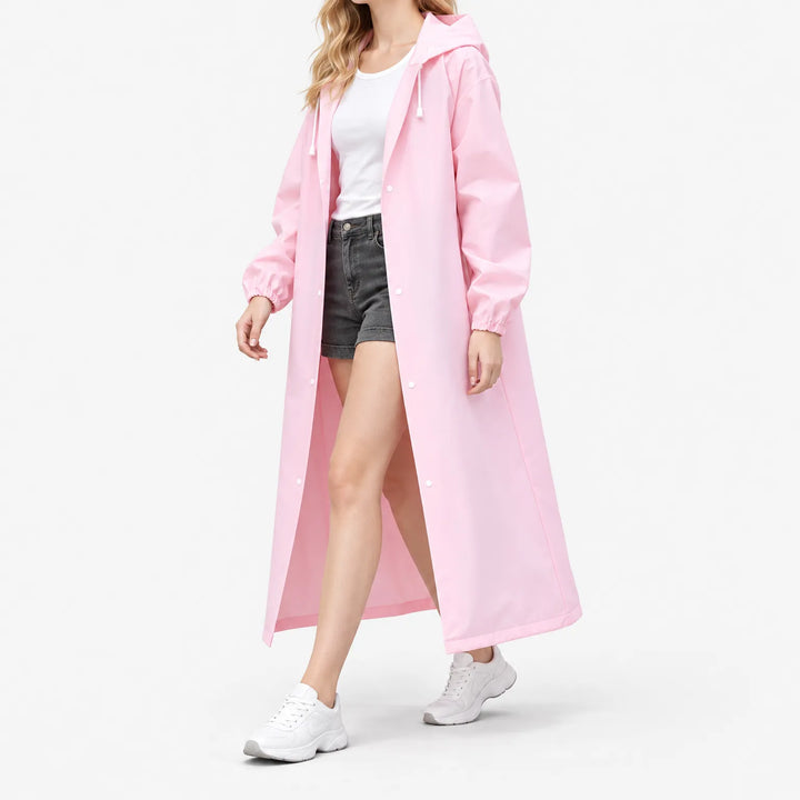 Woman walking in the pink hooded raincoat worn open over a white tee and denim shorts, shown from the side. 5
