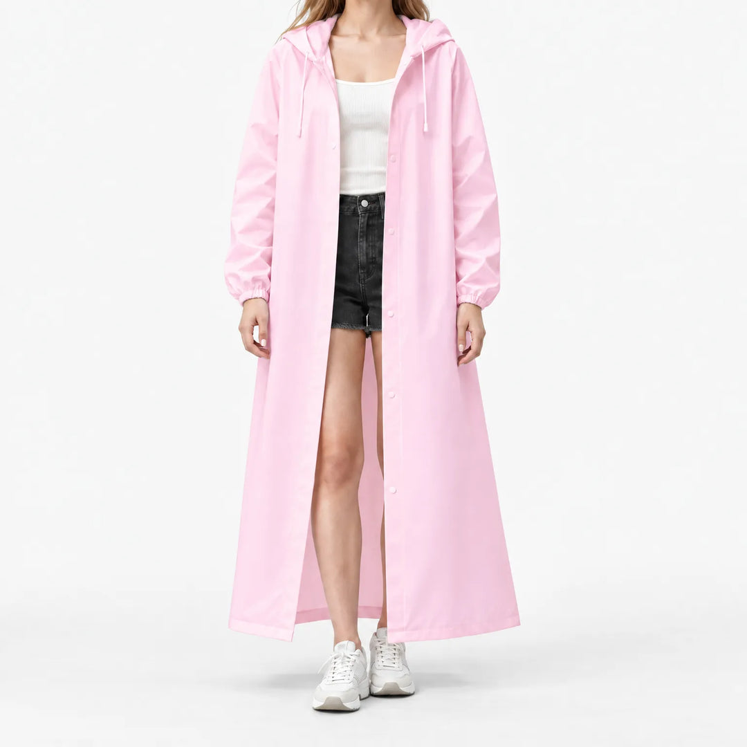 Studio front view of the pink hooded raincoat worn open over a white ribbed top and black shorts, with elastic cuffs. 7