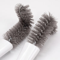 Close-up of two grey twisted-wire brush heads with dense, soft bristles, one bent at a right angle, against a white background. 3