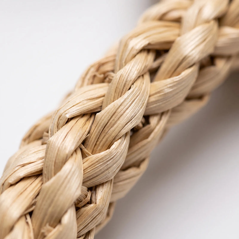 Close-up of a pale braided natural fibre strip, showing the twisted plaited weave and fine texture of the material. 3