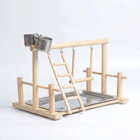Empty natural wooden bird playstand on a plain pale background, showing the top perch, hanging ladder, swing, two steel cups and steel tray. 1