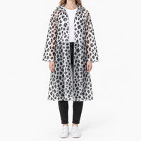 Front view of the translucent raincoat with black leopard spots, worn open over a white tee and black jeans. 8