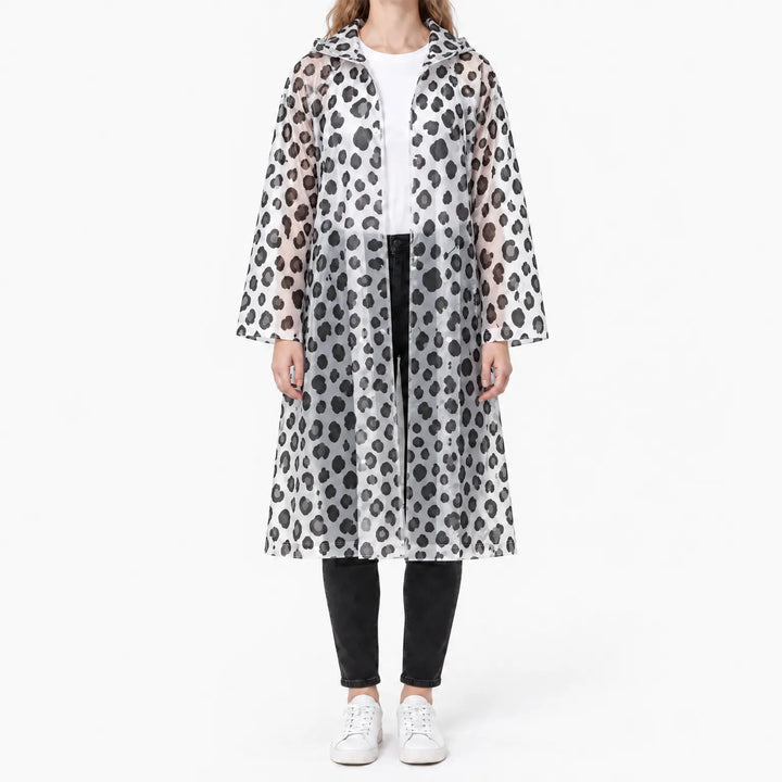 Front view of the translucent raincoat with black leopard spots, worn open over a white tee and black jeans. 8