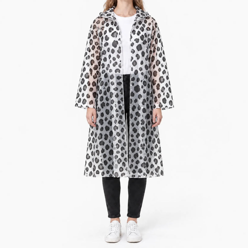 Front view of the translucent raincoat with black leopard spots, worn open over a white tee and black jeans. 8