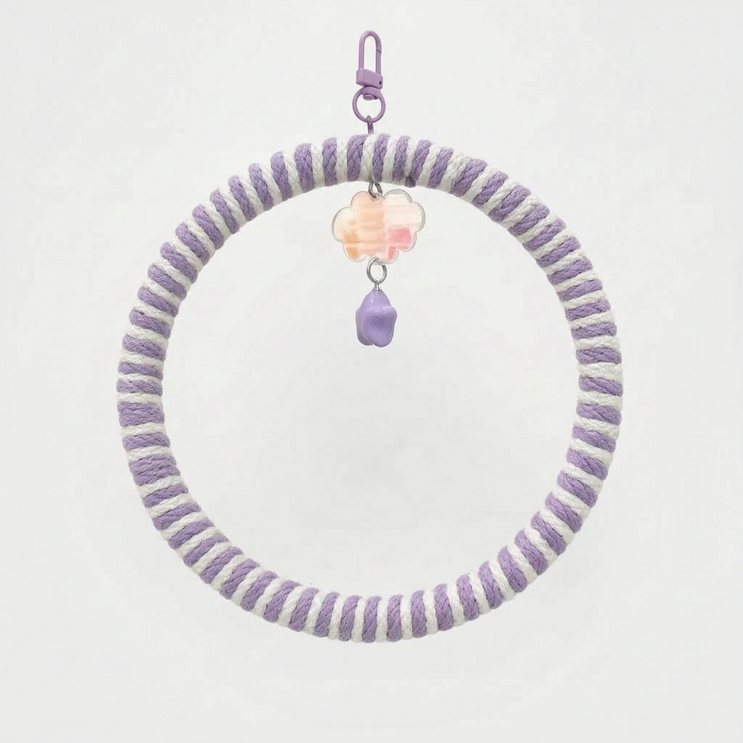 Ring swing wrapped in lilac and white rope, with a lilac clip, a pastel iridescent cloud charm and a purple star bead. 7