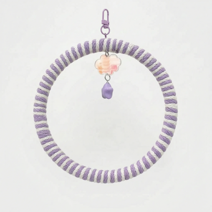 Ring swing wrapped in lilac and white rope, with a lilac clip, a pastel iridescent cloud charm and a purple star bead. 7