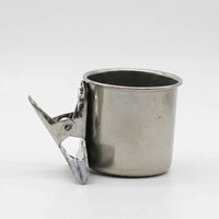 Side view of a single steel cup on a white background, with the open spring clip angled outwards. 6