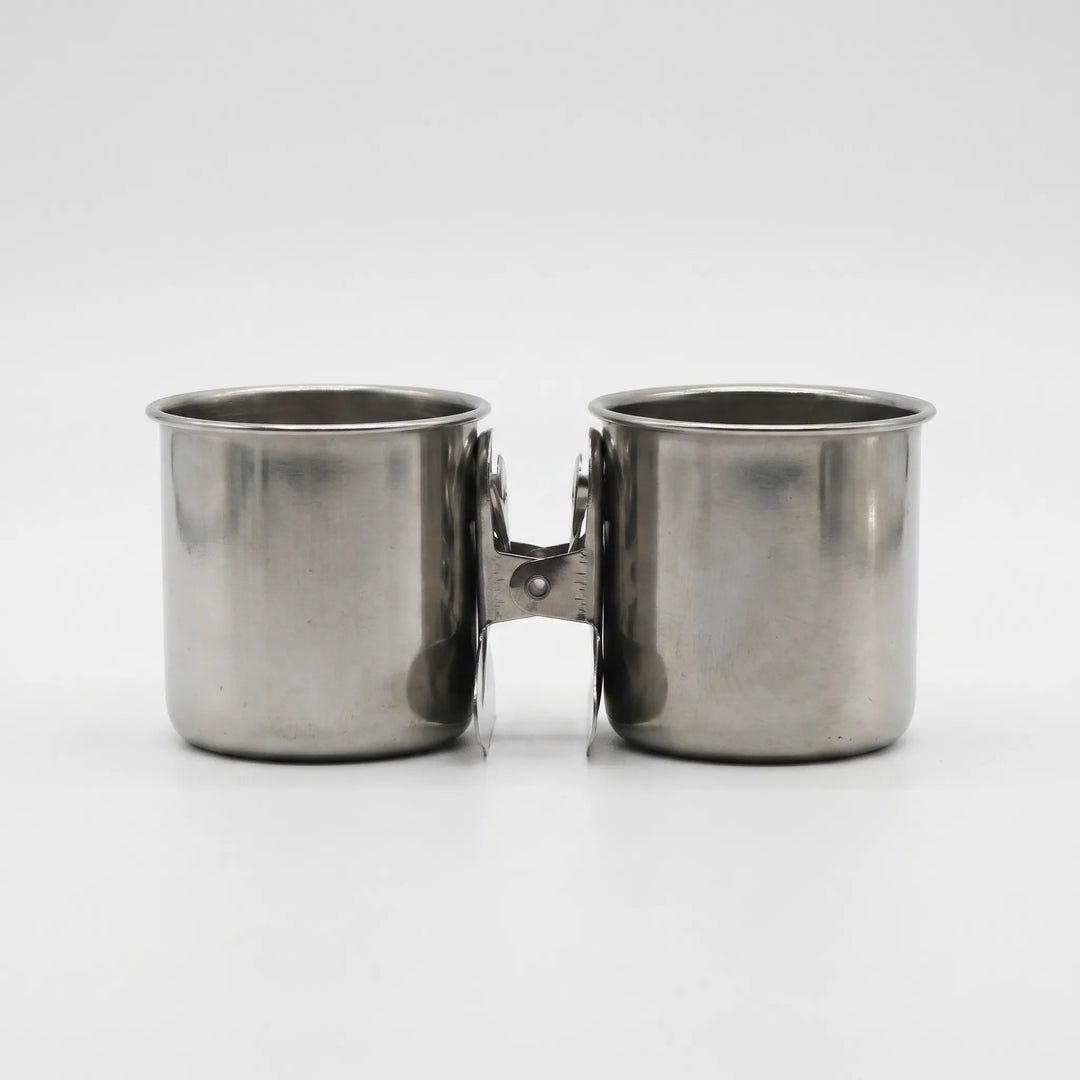 Pair of steel cups with their clips pressed together between them, shown from the front on white. 7