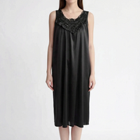 Front view of the black satin nightgown on a model, with dark floral lace yoke and ruffled V-shaped trim. 12