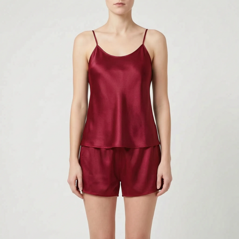 Front view of the camisole and shorts set in dark burgundy satin worn by a model. 12