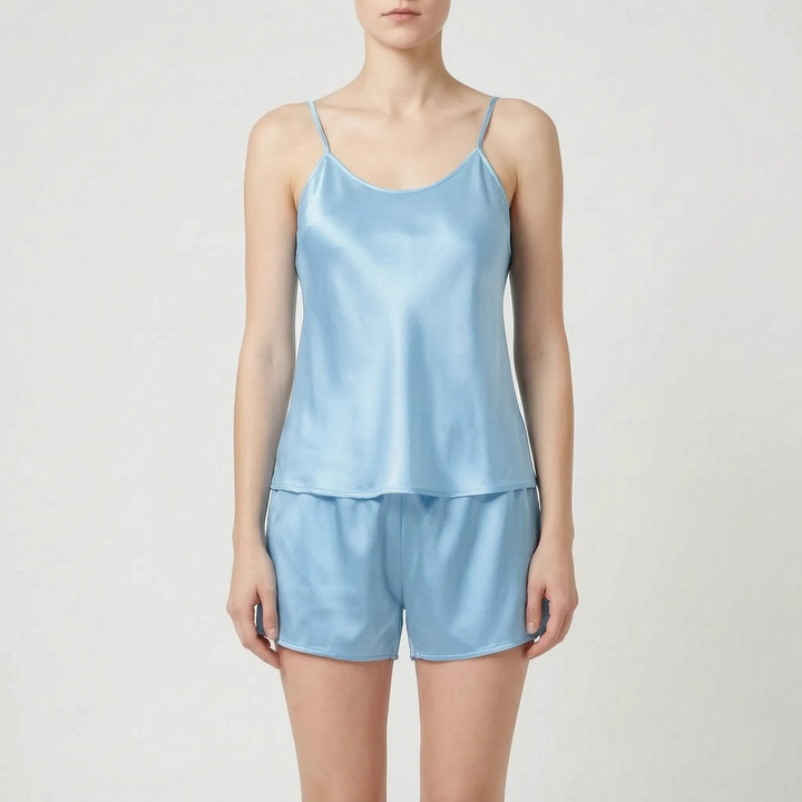 Front view of the camisole and shorts set in light sky blue satin worn by a model. 14