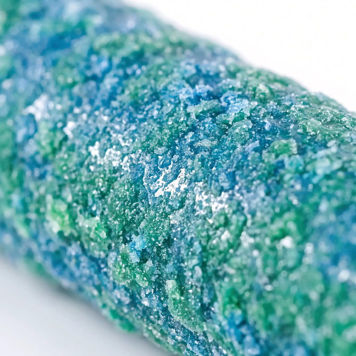 Close-up of the perch's coarse, sandy surface, mottled in blue and green, showing the rough grain birds grip. 4