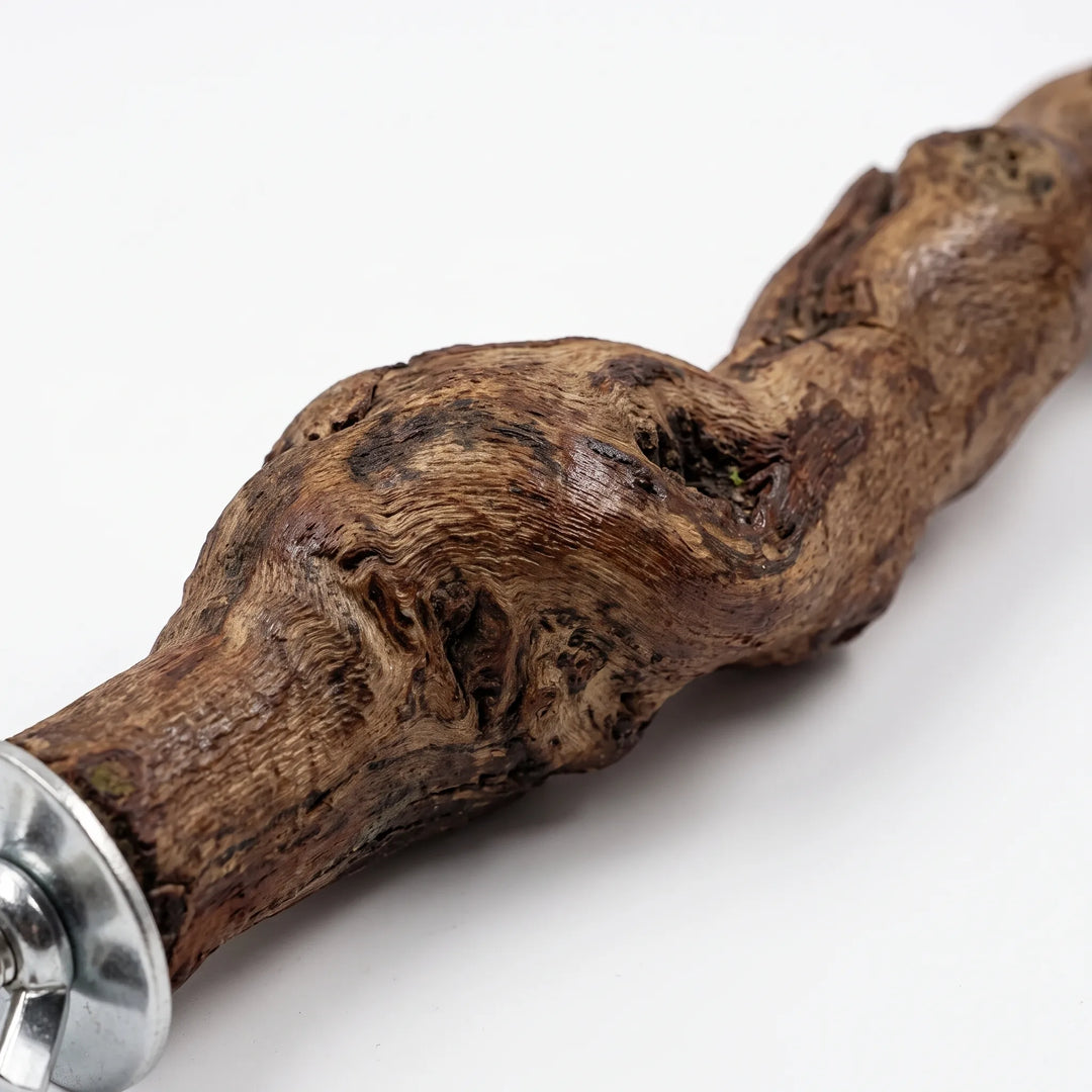 Close-up of the knotted, textured wood grain at one end of the perch, with its metal washer and wing nut. 3